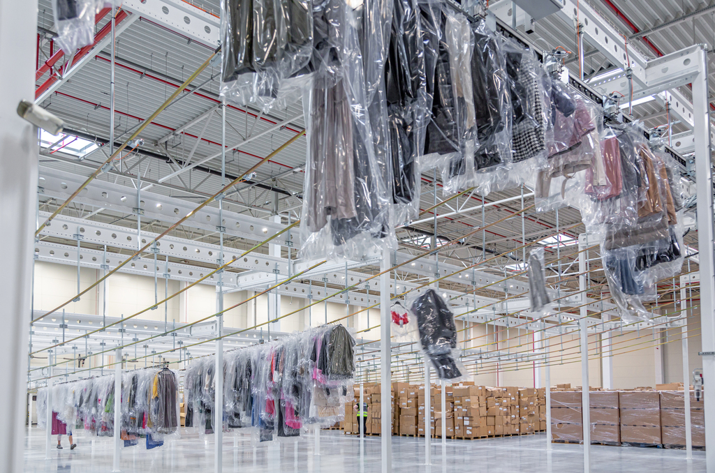 garments on hangers sliding to loading dock by garment rails